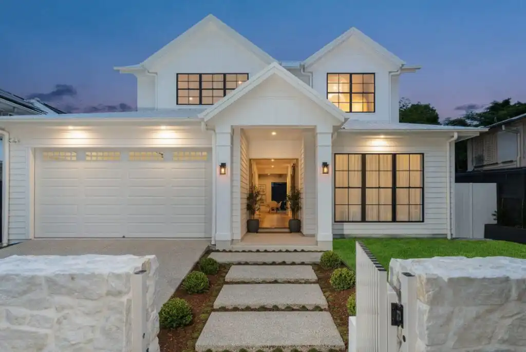 Casuarina natural stone cladding used on front fence walls of a contemporary white Queensland home