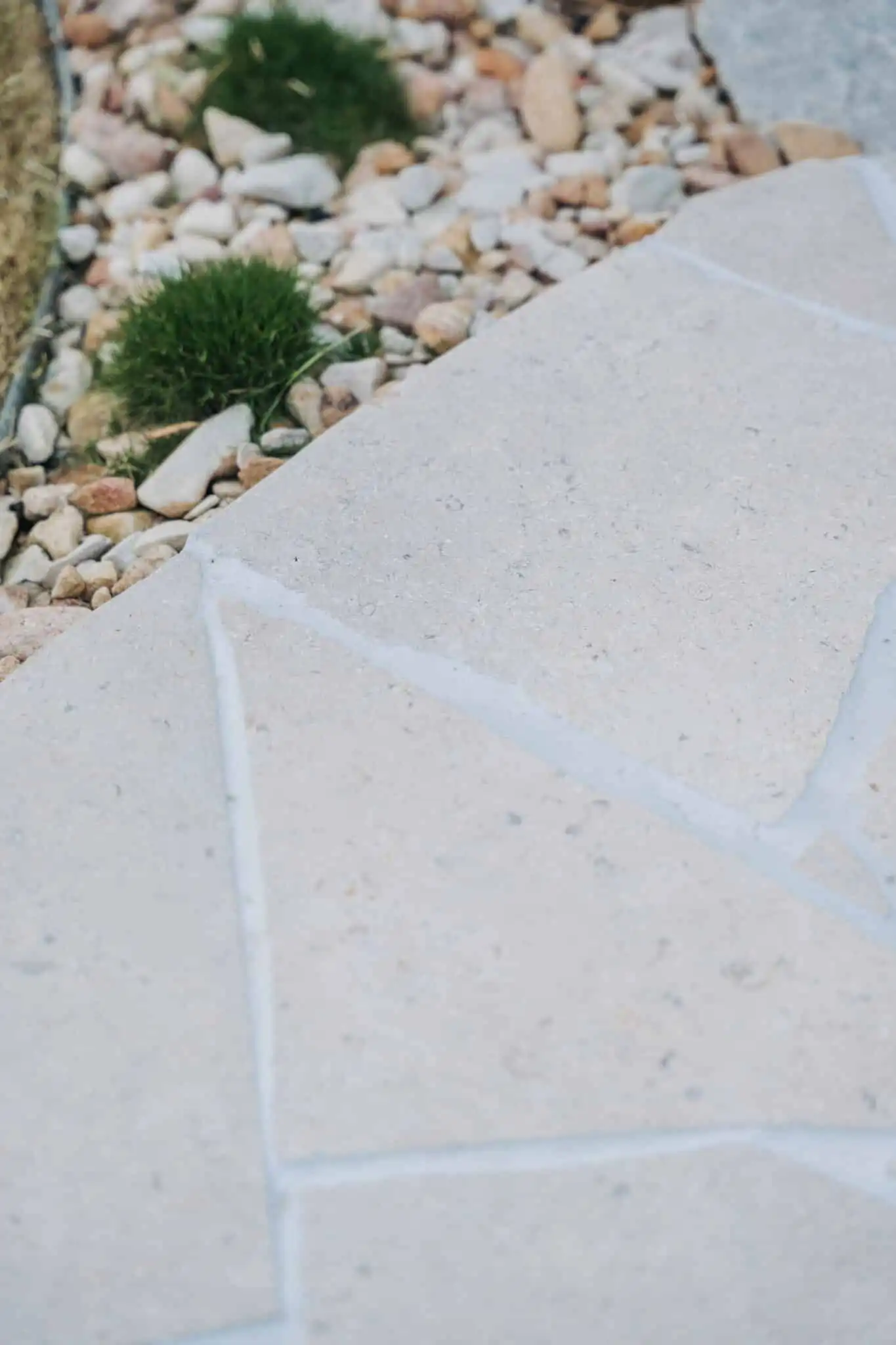 Sinai Pearl limestone crazy pave transitioning between lawn and landscaped garden beds