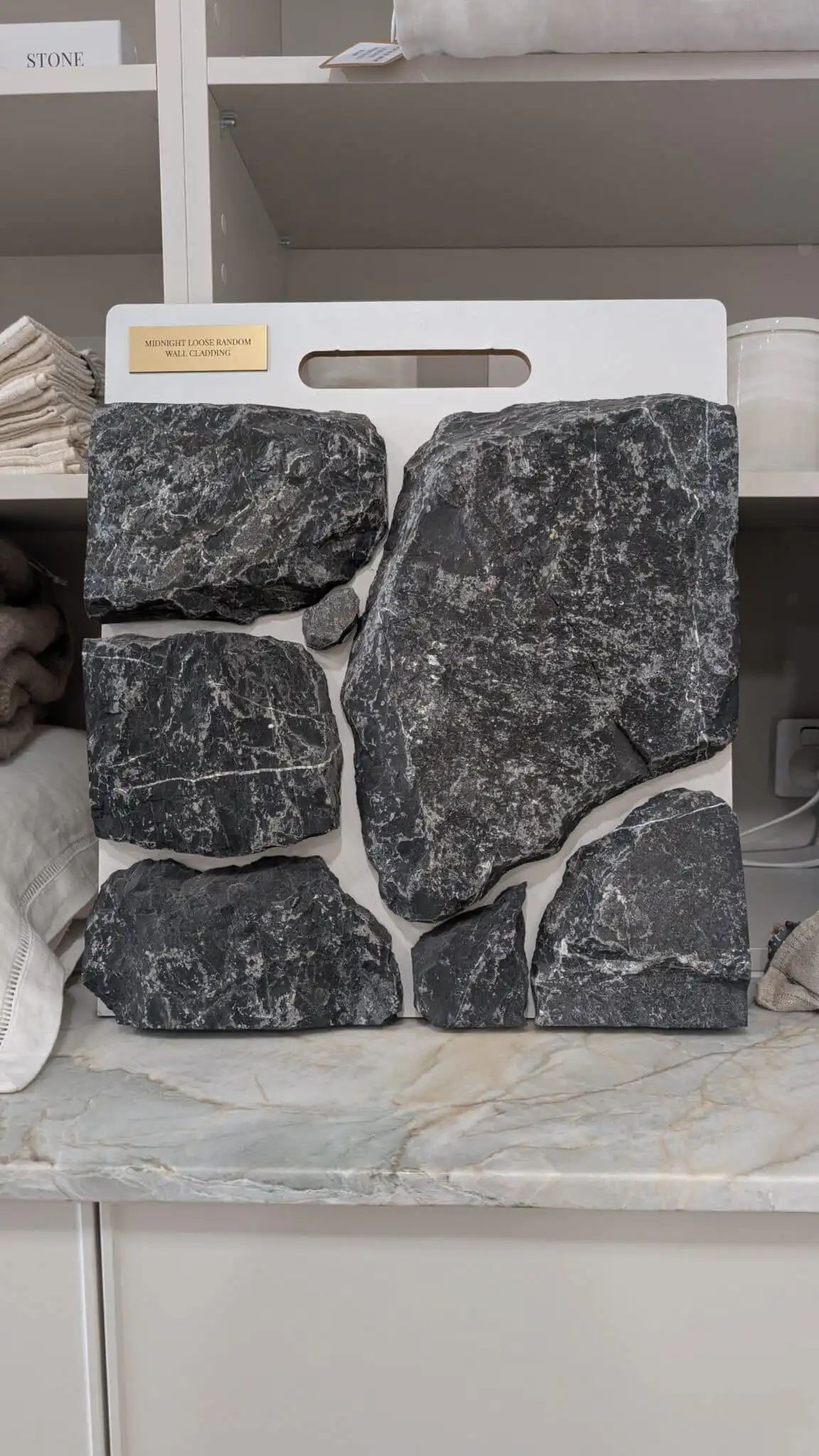 Limestone is a sedimentary stone that is formed in warm, shallow marine waters over millions of years. Composed mostly of calcium and fragments of marine organisms such as coral and shells. Midnight Loose Random Wall Cladding replicates the traditional stacked stone. Characterised by a dark charcoal colour, with striking white quartz veining throughout and tumbled to give you a rustic look. This cladding is an artisan crafted stone with tumbled and rocky edges to achieve an organic and textural aesthetic.
