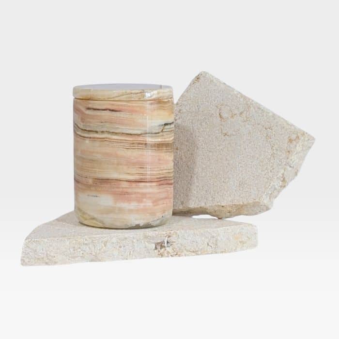 Natural onyx stone candle vessel with refillable insert, showcasing translucent veining and layered tones