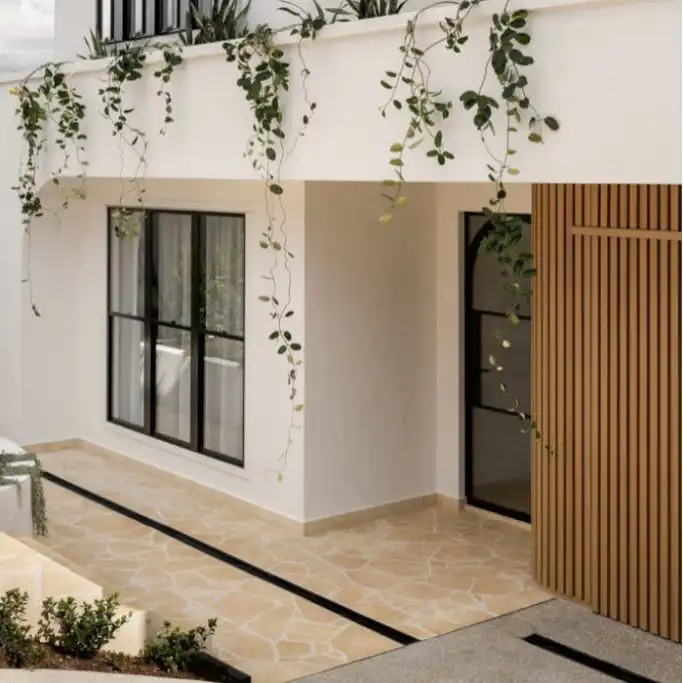 Natural stone crazy pave paving installed in a modern courtyard with irregular stone pattern and soft neutral tones