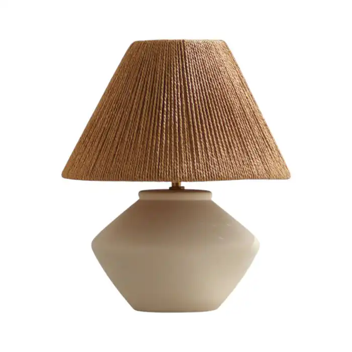Lucia table lamp by Paola and Joy featuring sculptural ceramic base and natural woven lampshade on neutral background
