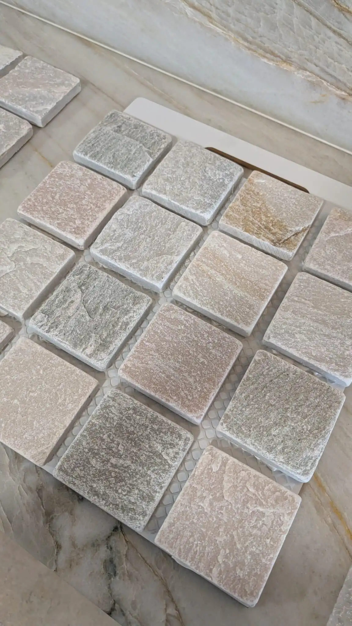 Sorrento Quartz tumbled cobblestone sample showcasing light grey, cream and blush natural stone variation