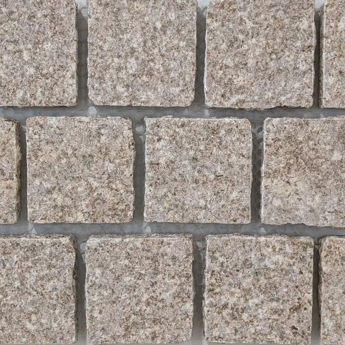 Warm speckled Biscotto Granite offset cobblestone in a 320 x 320 mm format